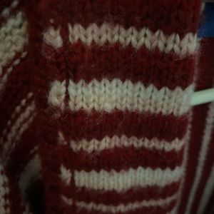 Red, pink and white striped cardigan sweater.